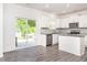 Bright kitchen with stainless steel appliances, granite counters, white cabinets, and sliding glass door to backyard at 516 Spaulding St, Burlington, NC 27215