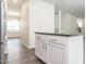Bright kitchen island features granite counters and white cabinets, complemented by modern stainless steel appliances at 516 Spaulding St, Burlington, NC 27215