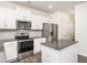 Stylish kitchen with white cabinets, stainless steel appliances, and a granite-topped island at 516 Spaulding St, Burlington, NC 27215
