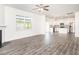 Open living space with gas fireplace, hardwood floors, and a view of the modern kitchen at 516 Spaulding St, Burlington, NC 27215
