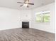 Bright living room features a gas fireplace, ceiling fan, and abundant natural light at 516 Spaulding St, Burlington, NC 27215