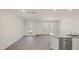Dining area boasts wood-look flooring, back door, and kitchen with granite counters and stainless dishwasher at 521 Fife Ct, Gibsonville, NC 27249