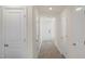 Bright hallway featuring multiple doors, neutral walls, and modern flooring, offering a clean aesthetic at 521 Fife Ct, Gibsonville, NC 27249