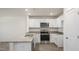 Modern kitchen featuring white cabinets, stainless steel appliances, and granite countertops, offering style and functionality at 521 Fife Ct, Gibsonville, NC 27249