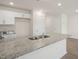 Kitchen with granite counters, stainless sink, white cabinets, and modern fixtures at 521 Fife Ct, Gibsonville, NC 27249