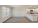 Open floor plan with bright living area, wood-look floors, and kitchen with stainless appliances at 521 Fife Ct, Gibsonville, NC 27249