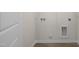 Utility room featuring washer and dryer hookups and wood-look flooring at 521 Fife Ct, Gibsonville, NC 27249