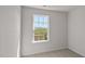 A bright bedroom with a large window overlooking a beautiful green field at 523 Fife Ct, Gibsonville, NC 27249