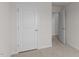 Hallway view with neutral colored carpet and white doors at 523 Fife Ct, Gibsonville, NC 27249