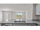Modern kitchen featuring granite countertops, stainless sink, and scenic window view at 523 Fife Ct, Gibsonville, NC 27249