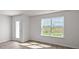 Bright room featuring wood-look floors, fresh paint, and a scenic window at 523 Fife Ct, Gibsonville, NC 27249