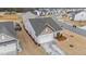 Aerial view of house highlighting attached garage, landscaping, and proximity to neighborhood at 629 Kenyon Spring Dr, Zebulon, NC 27597