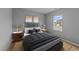 Tastefully designed bedroom with stylish lamps, hardwood floors, and plush bedding at 629 Kenyon Spring Dr, Zebulon, NC 27597
