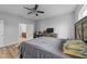 Spacious bedroom features wood floors, ceiling fan, and ensuite bathroom access at 629 Kenyon Spring Dr, Zebulon, NC 27597