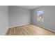 Bright bedroom with hardwood floors and a view of the street at 629 Kenyon Spring Dr, Zebulon, NC 27597
