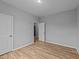 Clean bedroom featuring neutral walls, hardwood floors, and a walk-in closet at 629 Kenyon Spring Dr, Zebulon, NC 27597