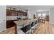 Open-concept kitchen featuring granite countertops, stainless steel appliances, and bar stool seating at 629 Kenyon Spring Dr, Zebulon, NC 27597