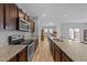 Well-lit kitchen featuring granite countertops, stainless-steel appliances, and wood-style flooring at 629 Kenyon Spring Dr, Zebulon, NC 27597