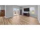 Cozy living room with sliding glass doors and entertainment unit below flat screen TV at 629 Kenyon Spring Dr, Zebulon, NC 27597