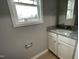 Well-lit bathroom with granite countertop vanity, white cabinets, and window at 76 Mangrove Ct, Four Oaks, NC 27524