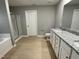 Bright bathroom with granite countertops, double sinks, soaking tub, and a glass-enclosed shower at 76 Mangrove Ct, Four Oaks, NC 27524