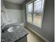 Bathroom featuring granite countertops and a window at 76 Mangrove Ct, Four Oaks, NC 27524