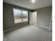 Neutral bedroom features a closet and view of the yard through the window at 76 Mangrove Ct, Four Oaks, NC 27524