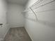 Walk-in closet with a single wire shelf and rod for hanging clothes at 76 Mangrove Ct, Four Oaks, NC 27524