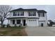 Charming two-story home featuring a two-car garage and a covered front porch at 76 Mangrove Ct, Four Oaks, NC 27524