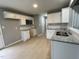 Modern kitchen featuring stainless steel appliances, granite countertops and white cabinets at 76 Mangrove Ct, Four Oaks, NC 27524