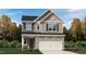 Charming two-story home with stone accents, a two-car garage, and a beautifully landscaped front yard at 764 Swim Cave Ln, Wendell, NC 27591
