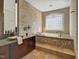 Luxurious bathroom with tiled walls, step-up tub, and granite countertops at 805 Greenwood Rd, Chapel Hill, NC 27514