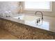 Elegant bathroom with granite countertops and a large soaking tub at 805 Greenwood Rd, Chapel Hill, NC 27514