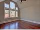 Spacious primary bedroom with a soaring ceiling, a ceiling fan, and a wall of windows at 805 Greenwood Rd, Chapel Hill, NC 27514