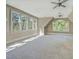 Spacious bedroom with neutral carpet, multiple windows and ceiling fans at 805 Greenwood Rd, Chapel Hill, NC 27514