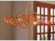 Close up of an artistic copper chandelier suspended from the ceiling at 805 Greenwood Rd, Chapel Hill, NC 27514
