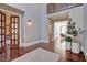 Inviting foyer featuring tall ceilings, rich wood flooring, and a decorative iron balcony at 805 Greenwood Rd, Chapel Hill, NC 27514