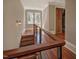 Hallway with stairs, metal and wood railings and wood treads, with closet in background at 805 Greenwood Rd, Chapel Hill, NC 27514