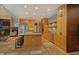 Open kitchen with stone accent wall, stainless appliances, island with bar seating and recessed lighting at 805 Greenwood Rd, Chapel Hill, NC 27514