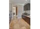 Well-equipped laundry room with a washer, dryer, sink, countertop, and storage cabinets at 805 Greenwood Rd, Chapel Hill, NC 27514