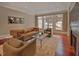 Cozy living room featuring a leather sofa, fireplace, and ample natural light at 805 Greenwood Rd, Chapel Hill, NC 27514
