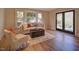 Bright living room featuring hardwood floors, a plush sofa, area rug and natural light at 805 Greenwood Rd, Chapel Hill, NC 27514