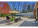 Outdoor patio area with comfortable seating, umbrella, and lush landscaping at 805 Greenwood Rd, Chapel Hill, NC 27514