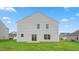 A well-maintained yard features a home exterior with sliding glass doors at 857 Forth Ct, Gibsonville, NC 27249
