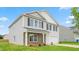 Charming two-story home featuring a two-car garage, stone accents, and a lush green lawn at 857 Forth Ct, Gibsonville, NC 27249