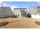 Back of home featuring a small backyard with brown grass, privacy fence and basic landscaping at 917 Matterhorn Dr, Fuquay Varina, NC 27526