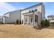 View of back of home and small backyard with screened in porch and simple landscaping at 917 Matterhorn Dr, Fuquay Varina, NC 27526