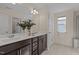 Bathroom with double sink, modern fixtures, and decorative plants to create a relaxing atmosphere at 917 Matterhorn Dr, Fuquay Varina, NC 27526