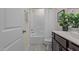 Bright bathroom features a shower-tub combo, dark vanity, white cabinets, and neutral wall paint at 917 Matterhorn Dr, Fuquay Varina, NC 27526