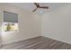 A bright, carpetless room with a ceiling fan and a window looking out onto the yard at 917 Matterhorn Dr, Fuquay Varina, NC 27526